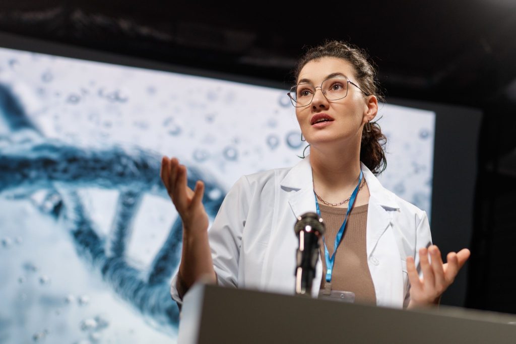Healthcare professional presenting scientific data during a medical conference