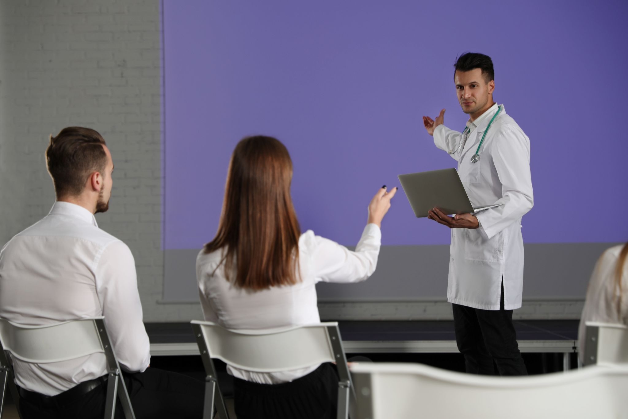 Doctor presenting to fellow advisory board members during a medical meeting